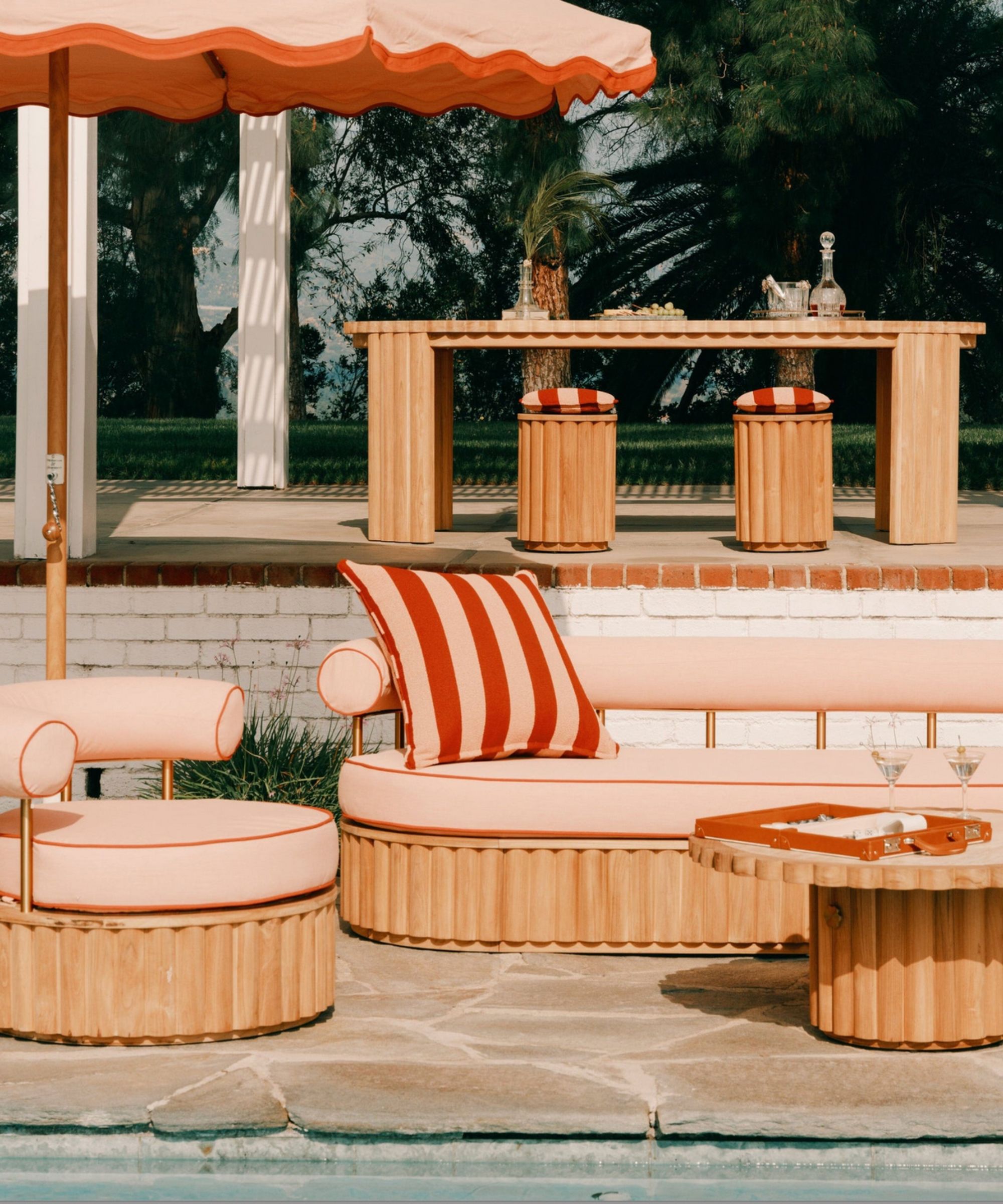 Retro resort-style outdoor pool furniture in pink and red stripes
