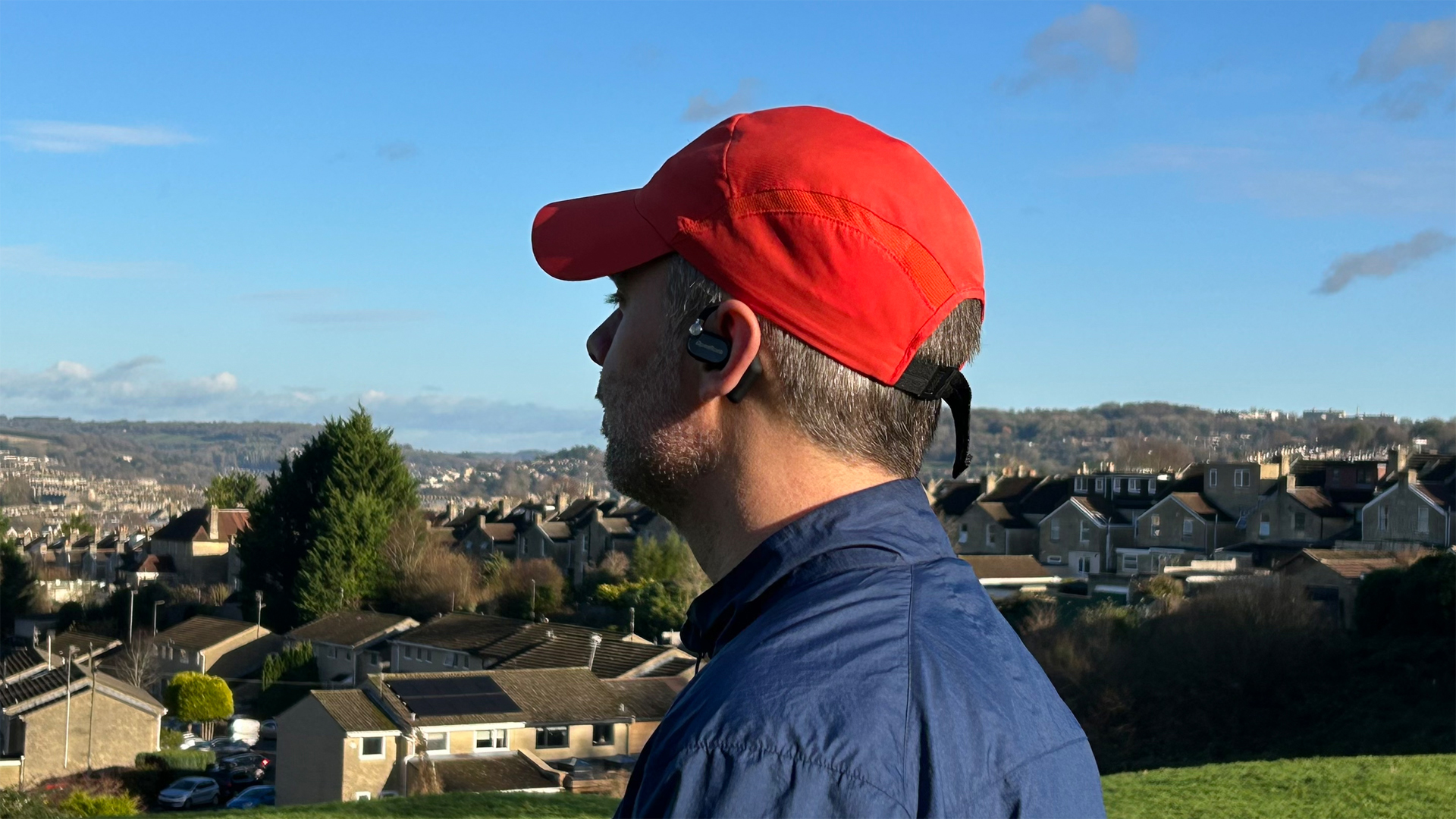 The reviewer wearing the OpenRock X headphones looking out over Bath