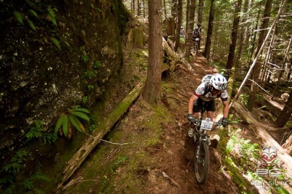 A rider negotiates some wooded singletrack.