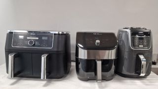A range of air fryers alongside eachother for testing