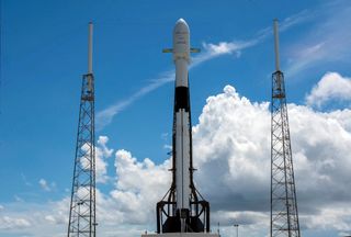 A SpaceX Falcon 9 rocket stands on the launch pad at Cape Canaveral Air Force Station in Florida before launching the Telstar 18 Vantage communications satellite into orbit on Sept. 10, 2018. The same booster will launch on its ninth flight May 4, 2021 to orbit 60 Starlink internet satellites. 