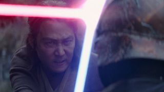 An older male adult Jedi, with a determined look on his face, is using his blue lightsaber to hold off the red lightsaber of his helmet-wearing opponent.