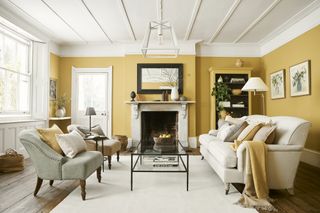 Yellow living room with white seating by Neptune