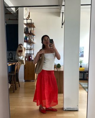 woman in red skirt and white top