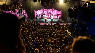 A live crowd watches a concert in 2025