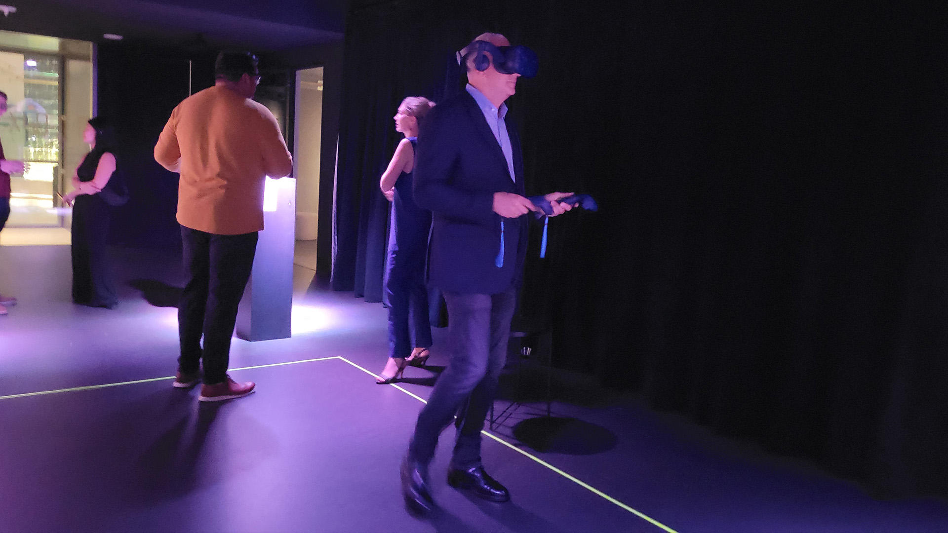 Retired NASA astronaut Mike Massimino experiences virtual reality at Ashley Zelinkskie's "Unfolding the Universe: First Light" exhibit.