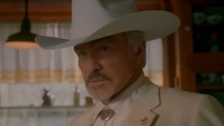 Burt Reynolds in a white cowboy hat and white suit as Boss Hog in The Dukes of Hazzard