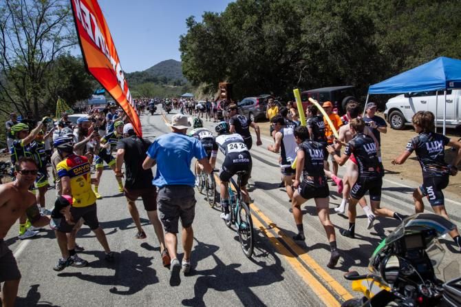 The two race leaders get cheered by fans on the climb