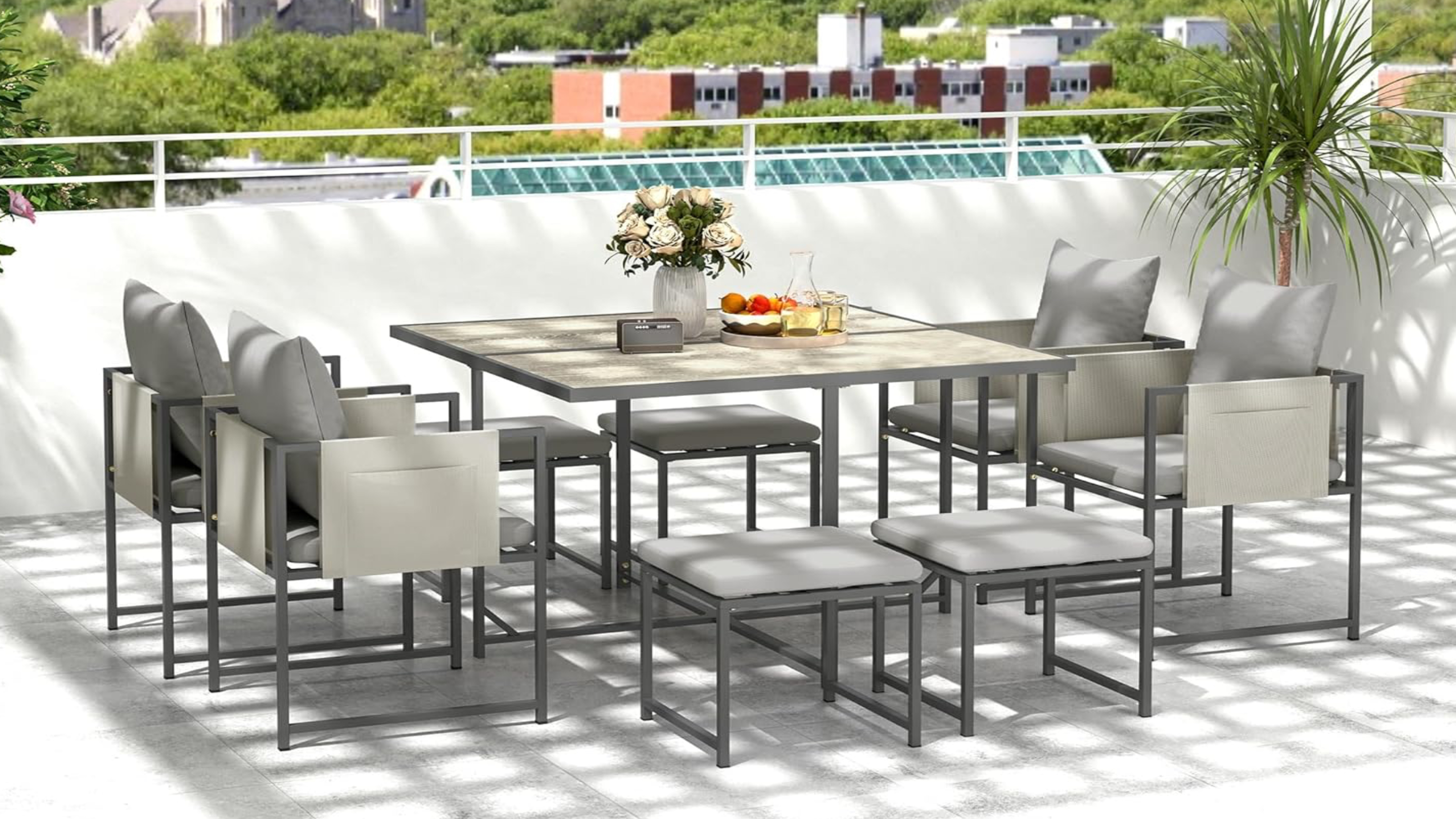 A garden patio with outdoor dining table and chairs