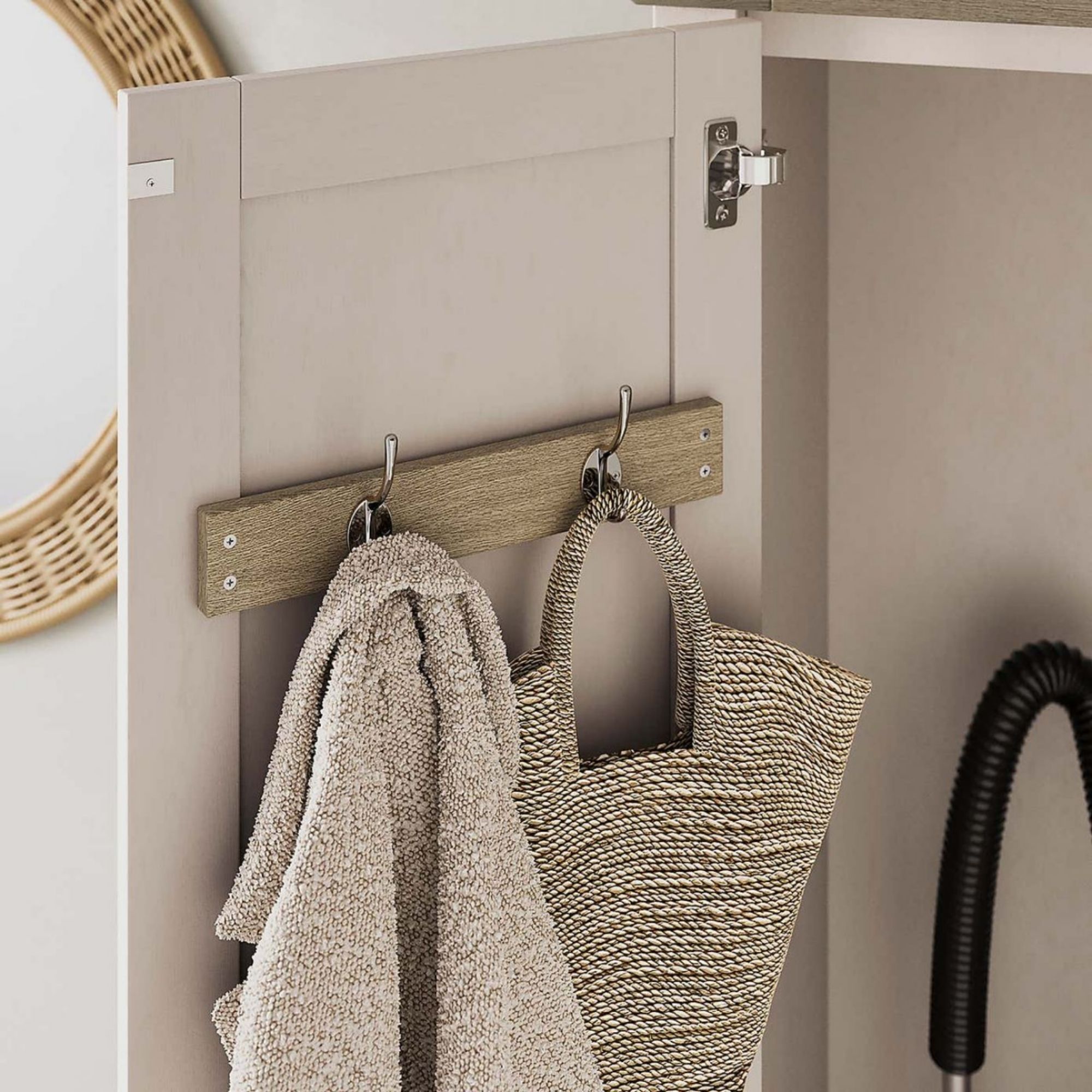 Close up of the hooks of the Olney Utility Cabinet, with a coat and bag hanging from them