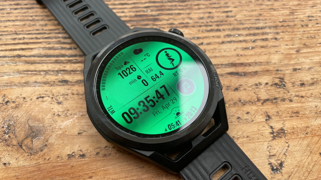 Huawei Watch GT Runner displaying alternative watch face including music, atmospheric pressure, and sunrise and sunset data