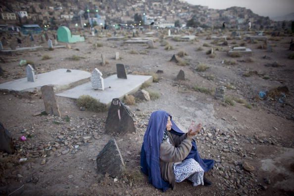 A woman visits the grave of her 26 year-old son, who was killed in an accident. 