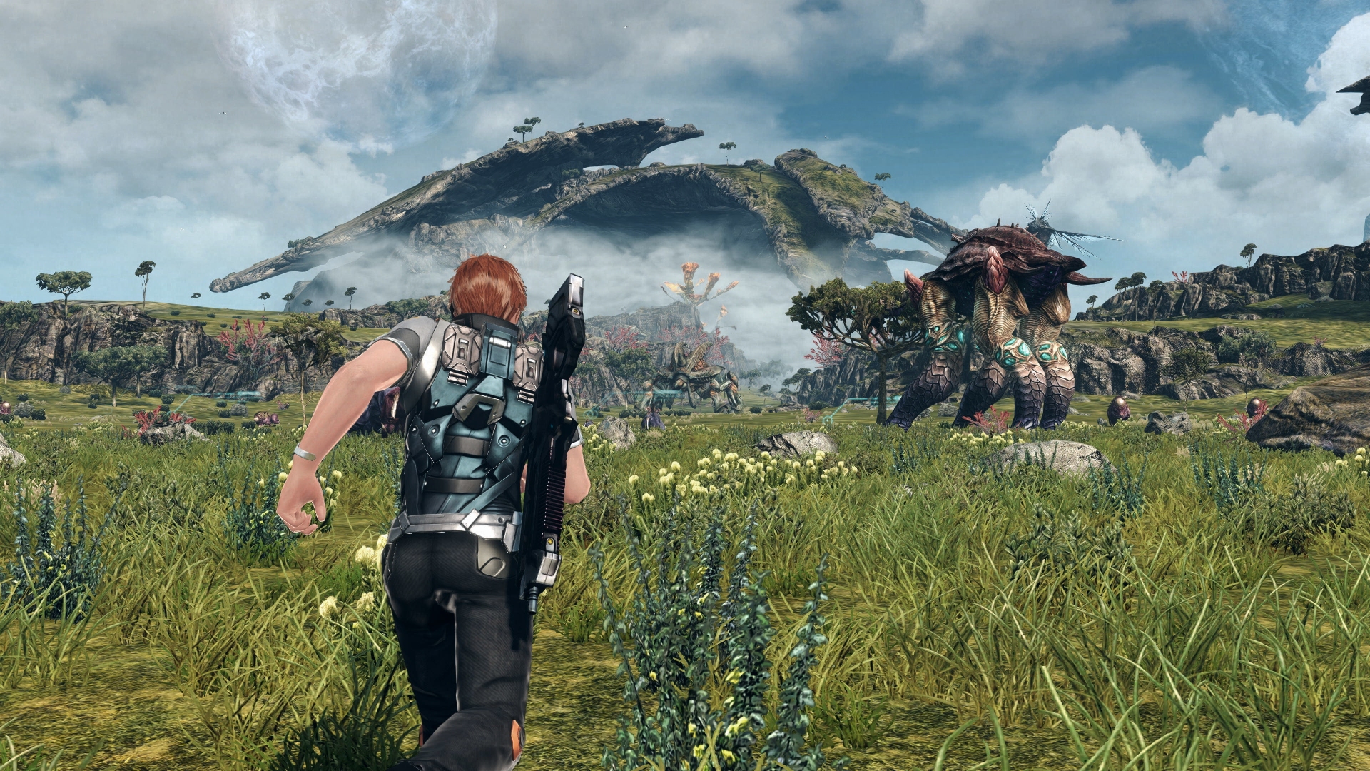 The protagonist runs across an open meadow in Xenoblade Chronicles X. Large fauna and towering mountains can be seen in the distance.