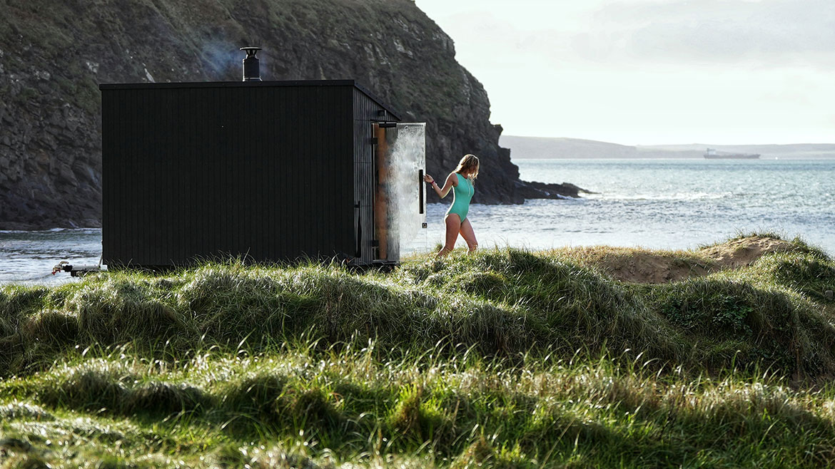 A lady stepping out of a sauna