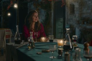 Zeynep sitting at a table surrounded by glasses and jugs
