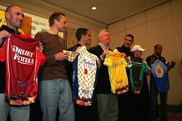 Riders and event officials present the jerseys