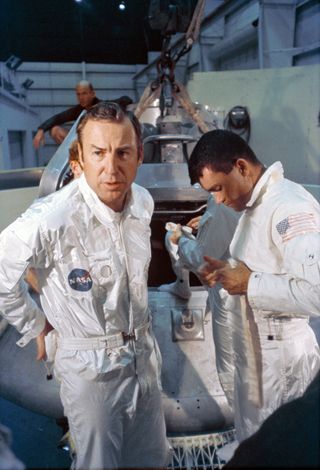 The Apollo 13 lunar landing mission prime crew members Jim Lovell (left), Fred Haise (right) and Ken Mattingly (behind Haise) prepare for water egress training inside Building 260 at the Manned Spacecraft Center in Houston. Mattingly, who was originally slated to fly on the Apollo 13 mission, was replaced by his backup crewmember, astronaut Jack Swigert, because he had been exposed to measles before the launch.