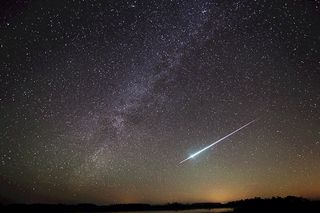 Meteor followed by a long streak of light pictured in the night sky in Florida