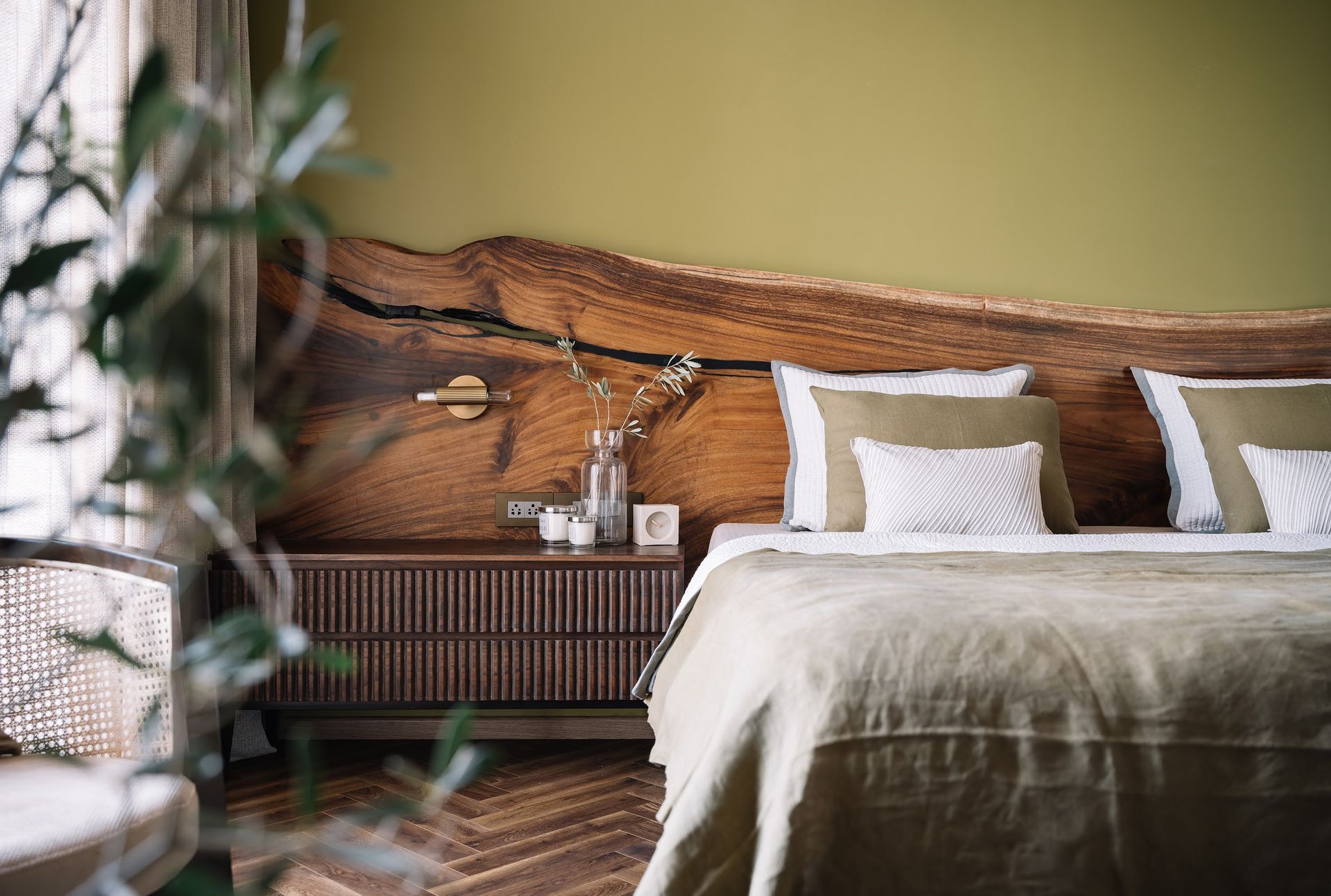 A bedroom with a long headboard in live edge wood