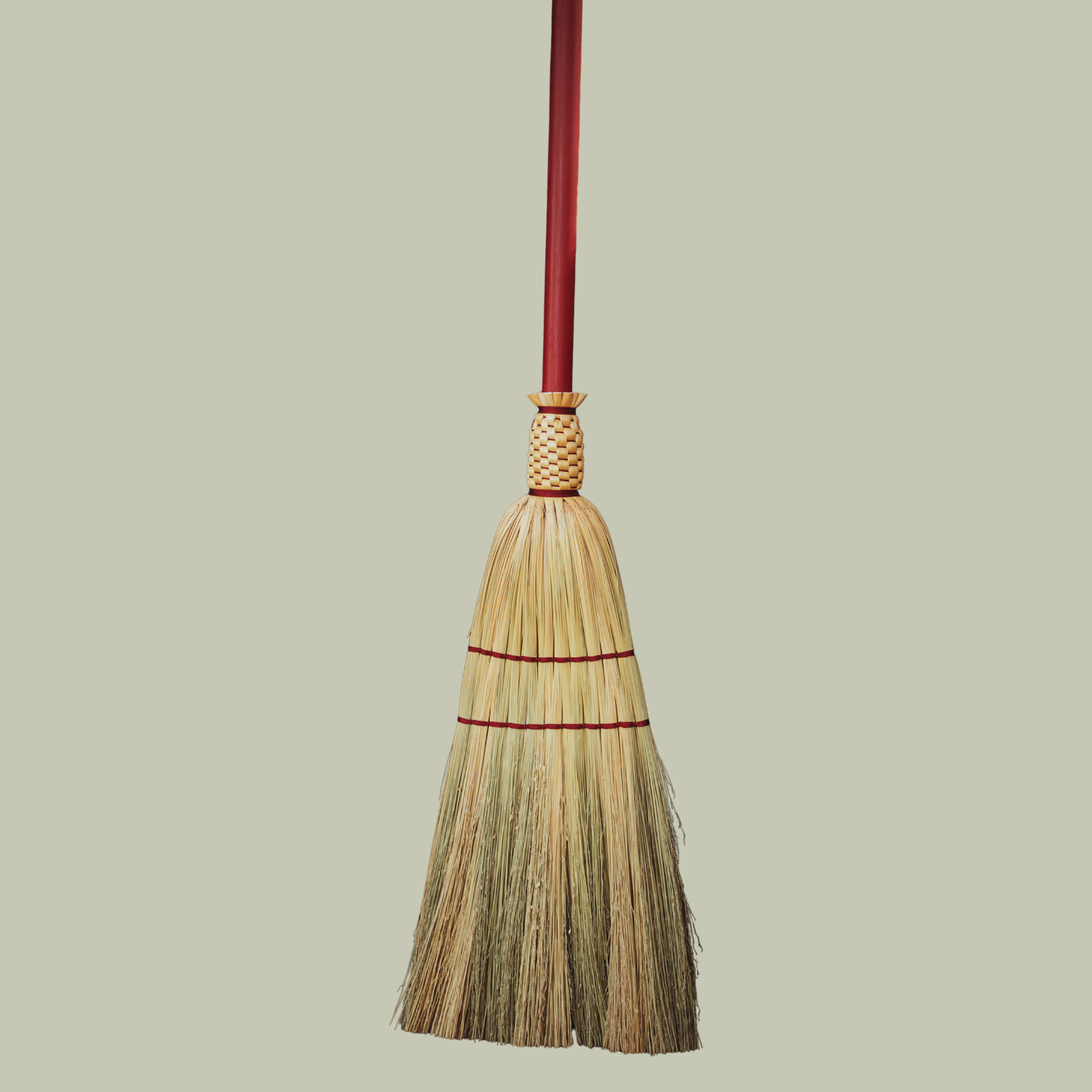 A red handmade broom