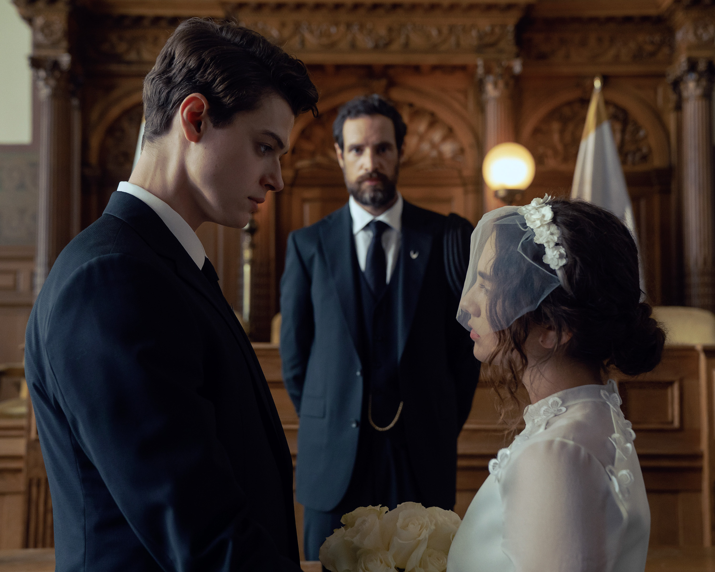 BRAD ALEXANDER as garth, CHARLIE CARRICK, and MATTEA CONFORTI as becka getting married in a church in the testaments season 1 finale