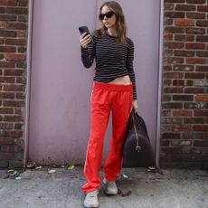 Nikki wears alo trail sneakers in nyc.