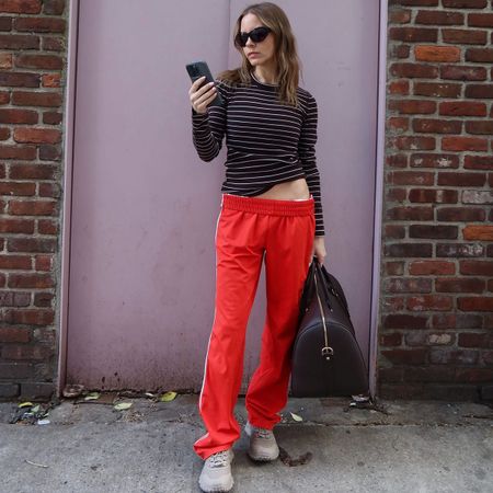 Nikki wears alo trail sneakers in nyc.