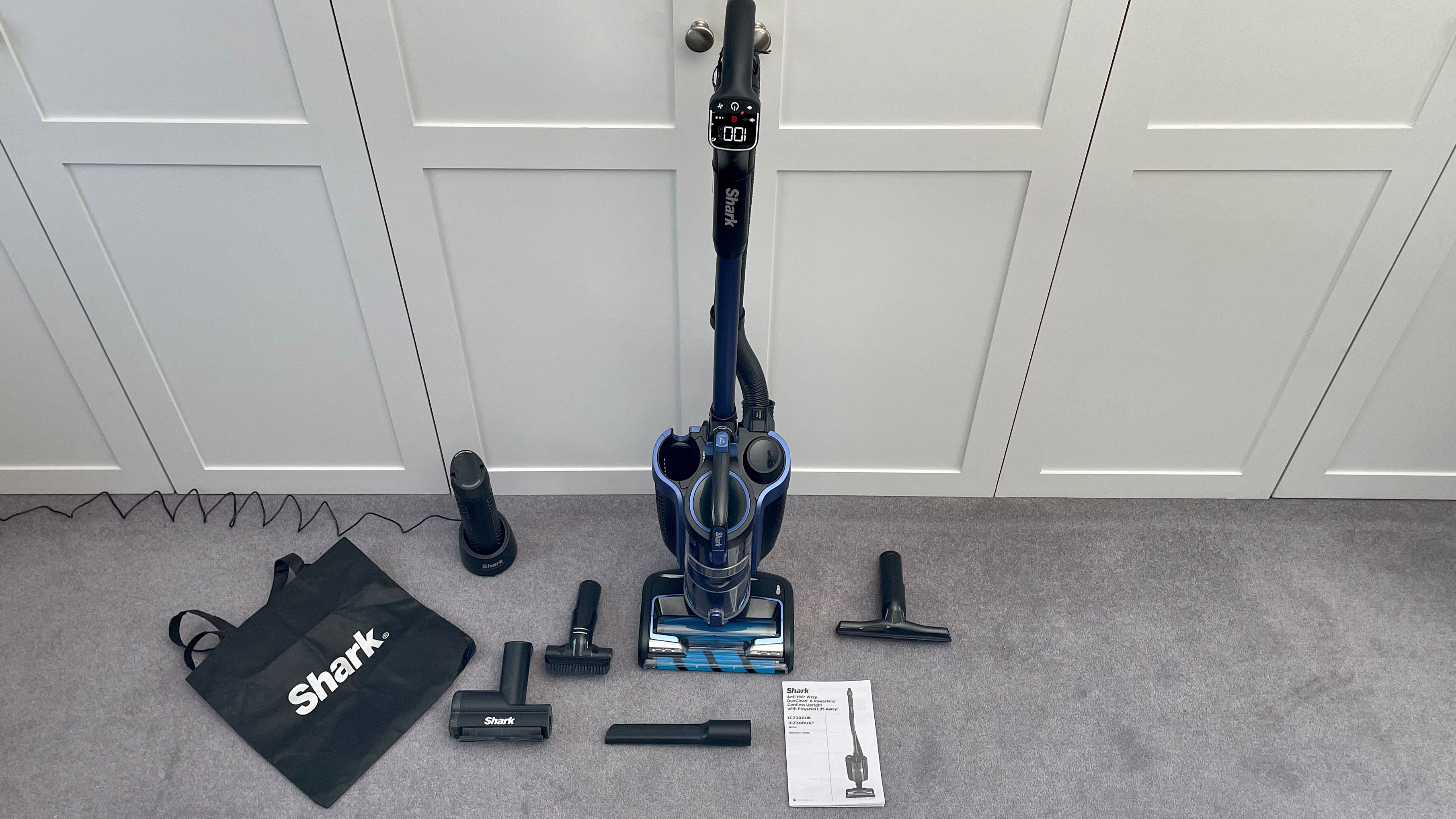 The Shark Anti Hair Wrap Cordless Upright Vacuum Cleaner with PowerFins, Powered Lift-Away & TruePet ICZ300UKT surrounded by all its accessories