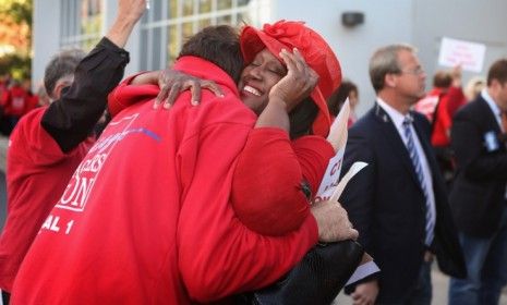 Chicago Teachers Union delegates embrace after ending their strike on Sept. 18.