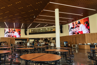 Mounted high in the dining hall are two 16-foot-wide-by-12-foot-high Planar DirectLight Essential Series LED video walls with 1.5mm pixel pitches.