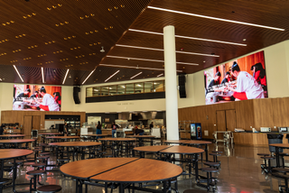 Mounted high in the dining hall are two 16-foot-wide-by-12-foot-high Planar DirectLight Essential Series LED video walls with 1.5mm pixel pitches.