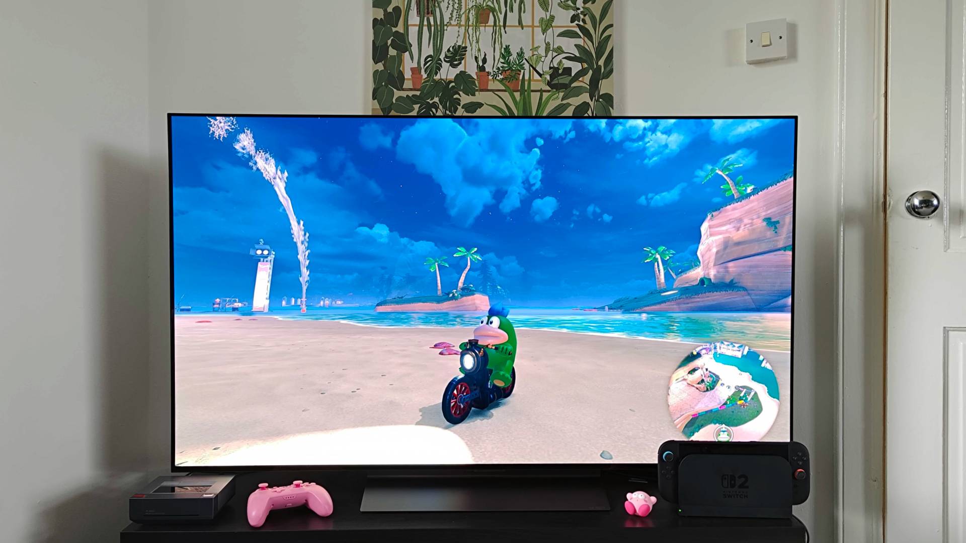 LG OLED C4 TV with Mario Kart World gameplay on screen and Spike as player character in beach in free roam mode.