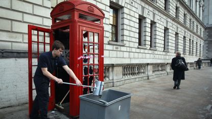 Red phone box smashed in London protest