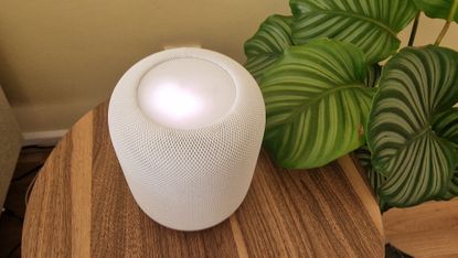 Apple Homepod 2 on wood side table being tested in writer's home
