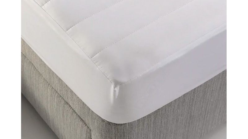 Dormeo mattress protector on a bed