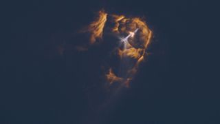 A giant rocket separating during stage separation, with fiery plumes in all directions.