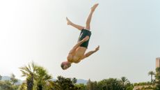 Man levitating like superhero, superman, somersaults and jumps, stunts and free running, capoeira