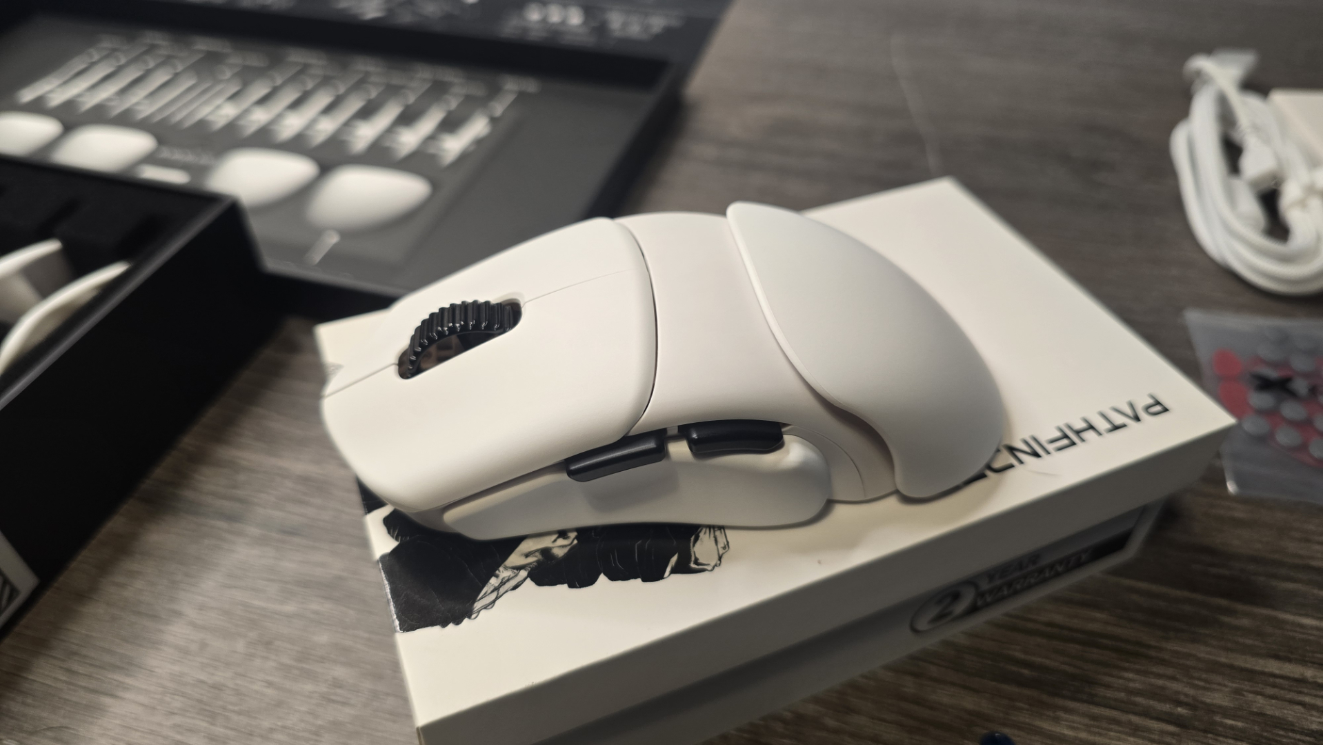 Orbital Pathfinder gaming mouse with various attachments.