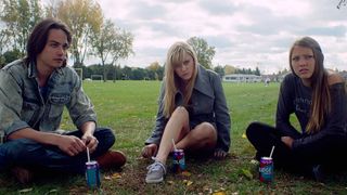 (L to R) Daniel Zovatto as Greg, Maika Monroe as Jay and Lili Sepe as Kelly sit in It Follows, one of the best Best horror movies on netflix