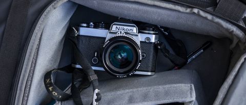 Nikon FE being held in a hand to show off the camera