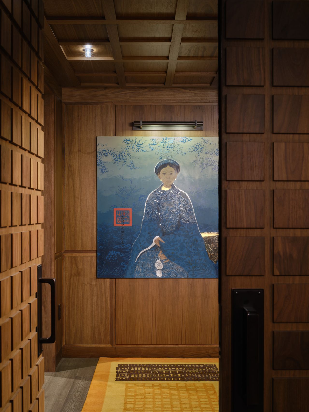 entryway with timber panelling, artwork, yellow rug