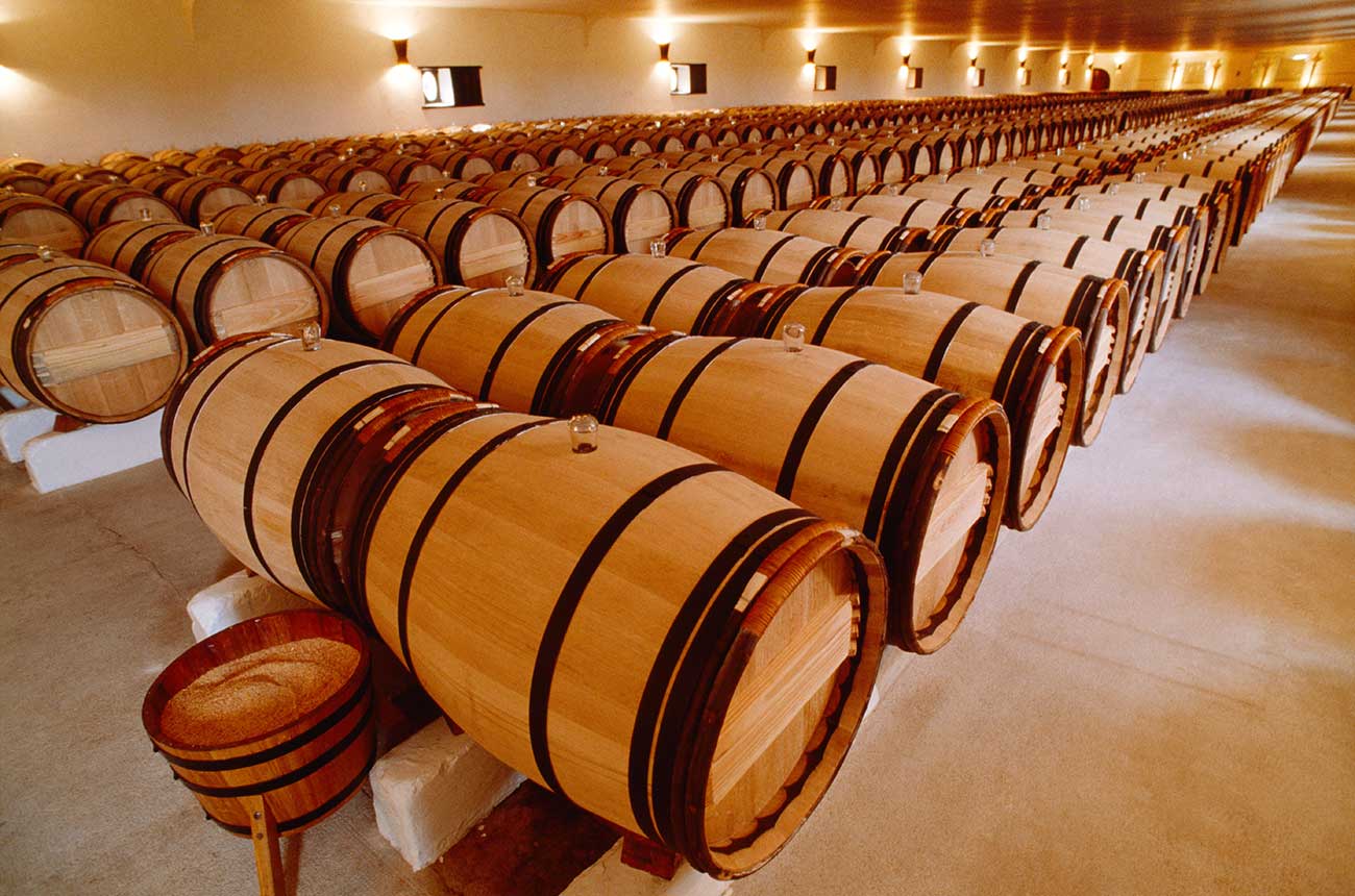 Barrels of wine ageing at Ch&amp;acirc;teau Mouton Rothschild in Bordeaux.
