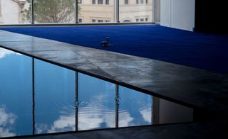 A swimming pool pictured against a glass window