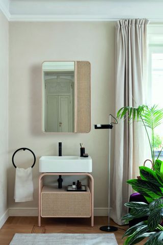 Washbasin with woven straw front cabinet in natural ash