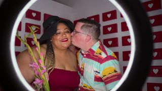 Nakysha getting a kiss on the cheek lit by a ring light in Jewish Matchmaking