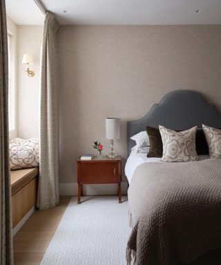 neutral bedroom with light brown walls and gray bedding