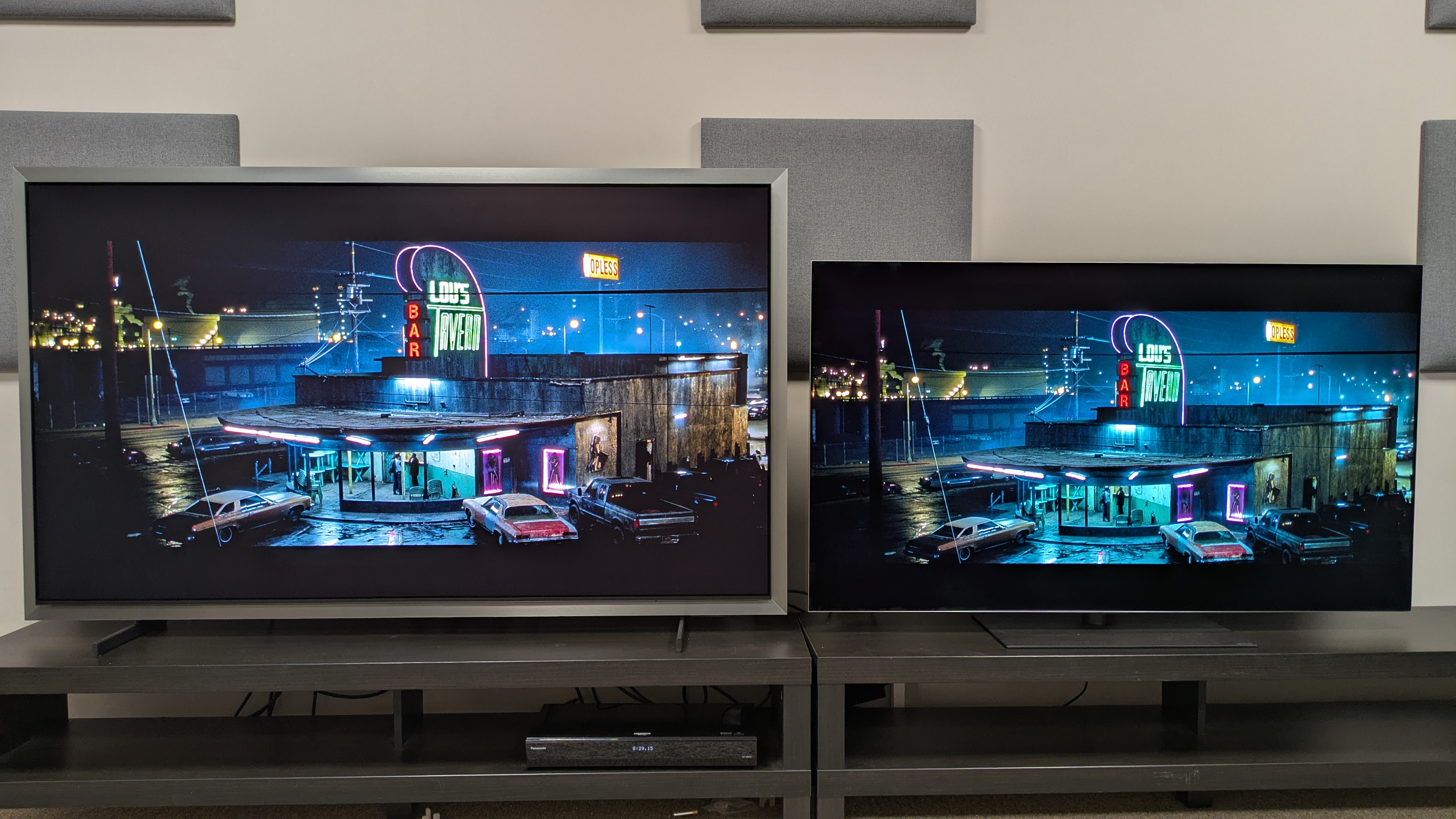 Samsung S99H (left) vs LG G6 (right) showing the exterior of Lou's tavern from Fight Club. Both TVs show punchy highlights, bold colors and strong contrast