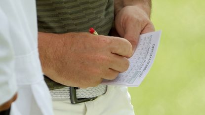 A close-up of Rory McIlroy marking his scorecard