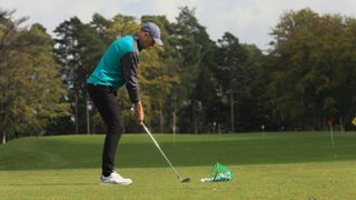 A golfer practising at a driving range