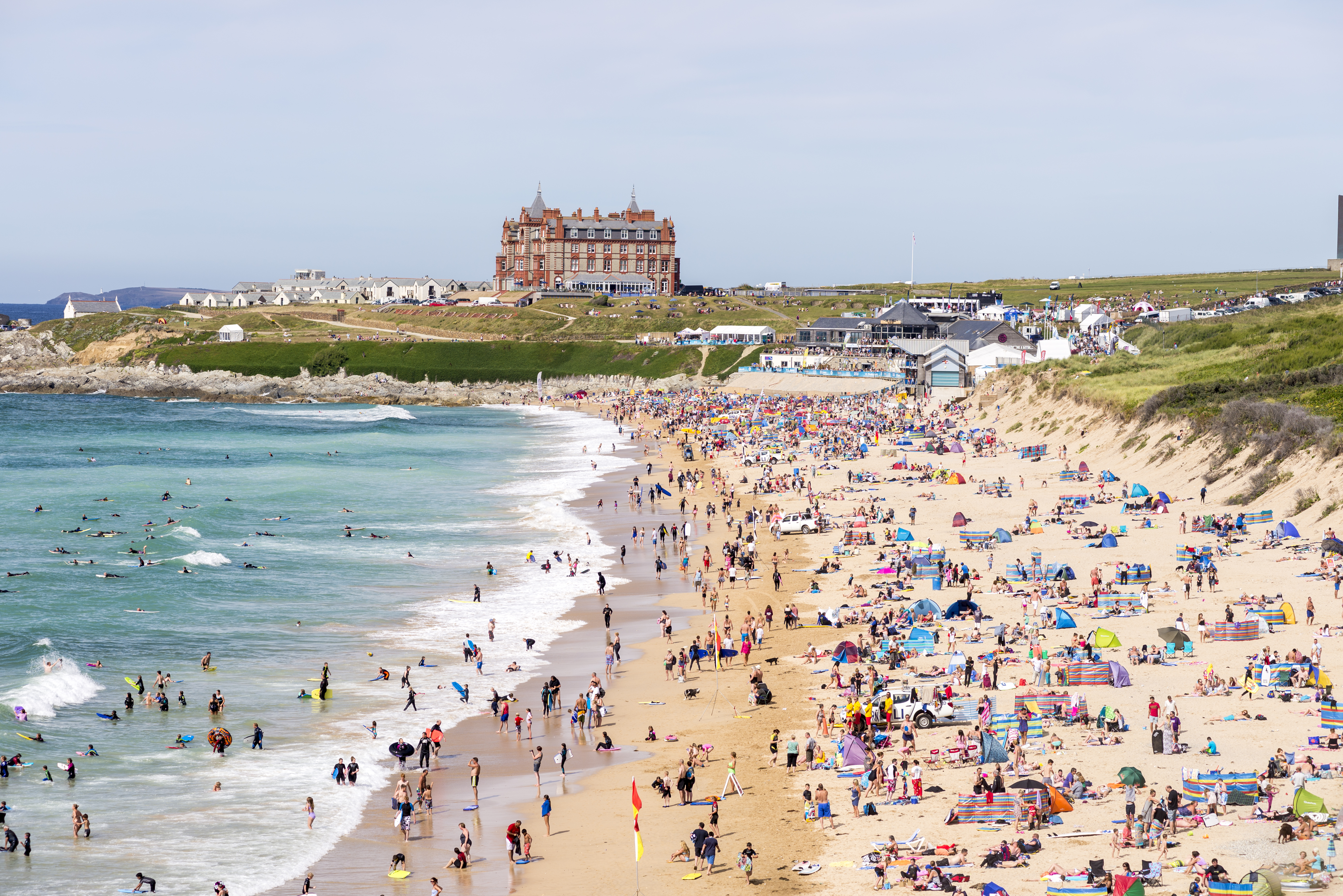 Newquay beach covered in tourists with tents and windbreakers